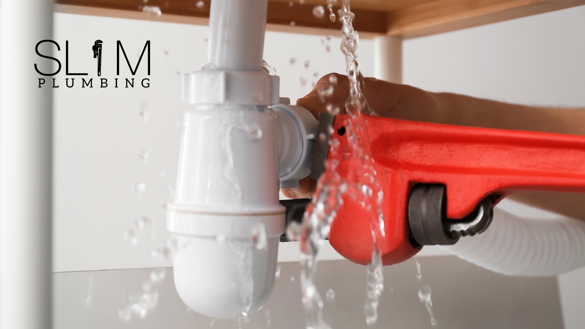 Plumbing Upgrades That Add Value by Slim Plumbing showing a plumber fixing a leaking pipe under a sink
